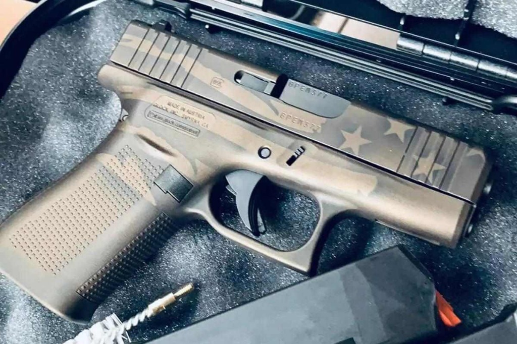 Custom finished handgun with stars and stripes pattern in a carrying case